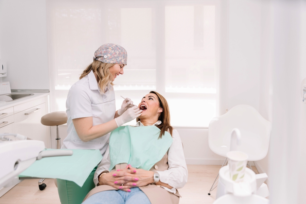 Female,Dentist,Examining,Patient’s,Teeth,In,Modern,Dental,Clinic
