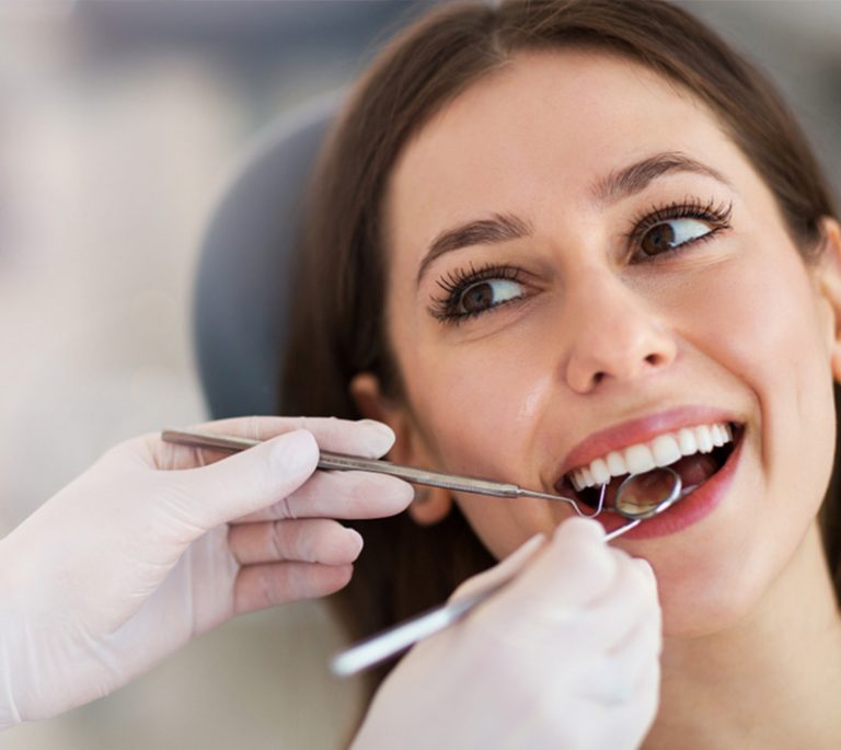 a lady is having dental fillings treatment