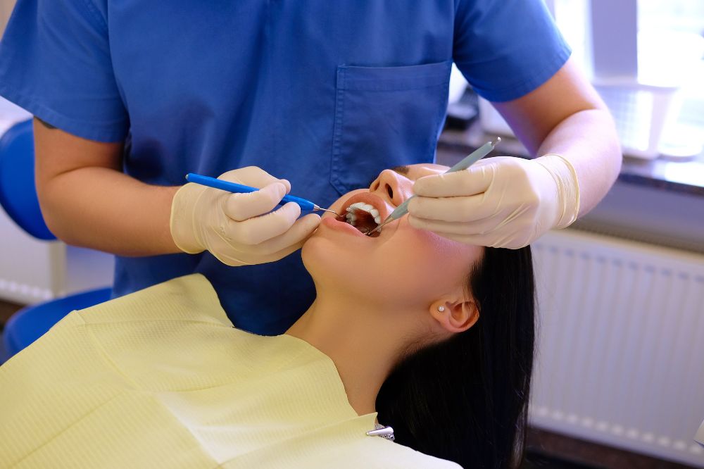 dentist hands working young woman patient with dental tools